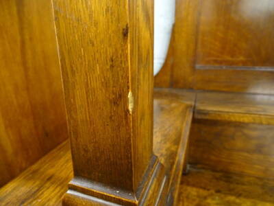 A late 19thC oak Arts and Crafts sideboard in the manner of Liberty, the raised back with two leaded glazed doors, each with hammered copper hinges and fittings, the bow fronted base with two drawers above two doors, with similar hammered fittings, on blo - 4