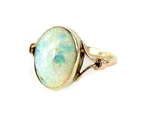 An opal dress ring, with oval cut opal stone, and v split design shoulders, in yellow metal setting, unmarked, ring size M, 2.1g all in, boxed.