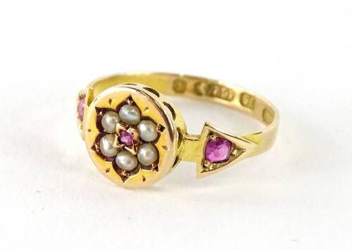 A 15ct gold dress ring, with central circular panel, set with flower and seed pearls and garnets, with garnet set triangle shaped shoulder, makers stamp O&Co, ring size M, 1.9g all in, boxed.