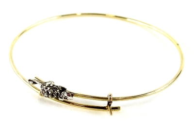 A mouse design bangle, set with single marcasite set mouse, with garnet eyes on yellow metal expanding bracelet, the mouse 1.8cm W, the bangle approx 6.5cm dia, yellow metal, bangle unmarked, the mouse white metal, 6.2g all in, in G Hewitt and Son of Grim