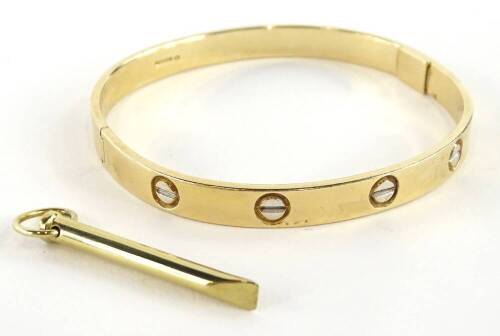 A 9ct gold bangle, with etched design, makers stamp BD, Sheffield assay, with winder, 6.5cm dia, 32.6g all in, boxed.