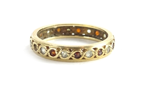 A yellow metal diamond ruby eternity ring, unmarked, 2.7g all in.