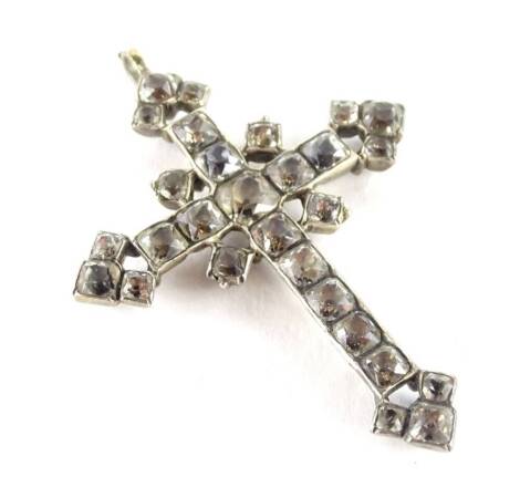 A late 19th/early 20thC crucifix pendant, set with white paste stones, in elaborate design, in silver coloured backing, unmarked, 5.5cm H x 4.2cm W, in W Pike and Son Limited Birkenhead box.