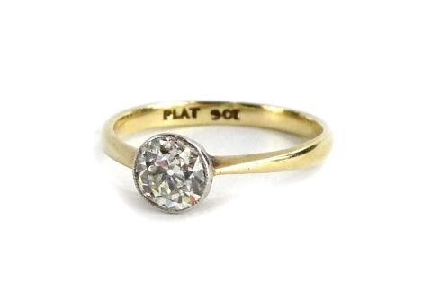 A 9ct gold and platinum diamond solitaire ring, set with round brilliant cut diamond, in platinum rub over setting, the diamond 5.4mm x 5.4mm x 3.6mm, approx 0.59cts, on a plain design band, ring size M, 1.7g all in, boxed.