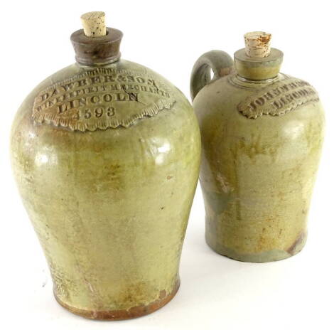 A 19thC baluster shaped stoneware flagon, for Dawber and Son of Lincoln, (AF), and another for John Thropp of Lincoln. (AF), (2)