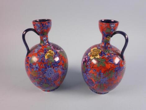 A pair of Cauldon flasks each printed and painted with flowers