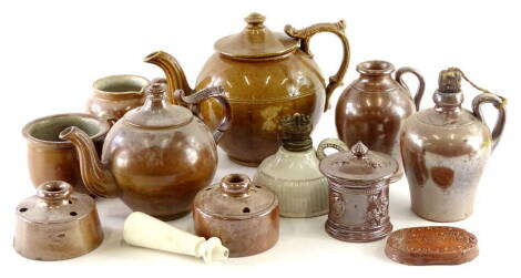 A collection of stoneware, to include a dark glazed teapot, small jar and cover, jug with side handle, small cup, two inkwells, etc.