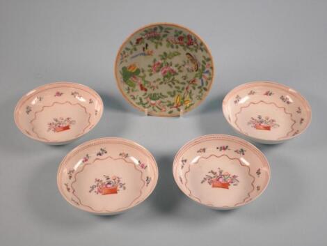 A set of four Chinese export saucers decorated with a basket