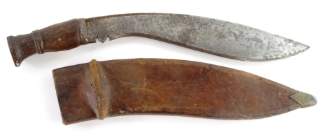 A First World War military Kukri, the curved blade stamped 1918 and with a hardwood handle, the leather scabbard and blade stamped with the date and military stamp, 48cm L.