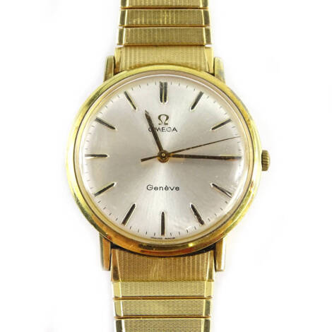 An Omega Geneve gentleman's wristwatch, with circular silvered dial, in gold coloured casing with a stainless steel back, on expanding stainless steel and gold plated watch strap, numbered 558, dial 3cm W.