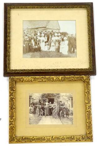 A late 19th/ early 20thC photograph, depicting ladies and gentleman beside a cottage with bicycles, 11cm x 15cm, and a similar wedding photograph. (2)