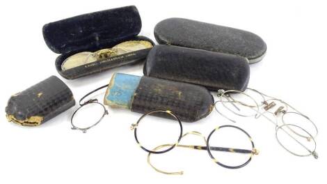 A collection of late 19th/early 20thC spectacles, to include simulated tortoise shell examples, with gold coloured metal rims, etc.