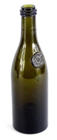 A late 19th/early 20thC Italian green glass bottle, with raised label for Bernet Toscano Italia, 25cm H.