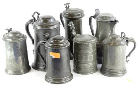 A collection of seven 19thC and later lidded pewter tankards, each with a shaped thumb piece, to include a Continental example with gnome shaped thumb piece, various touch marks.