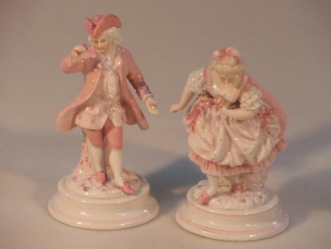 A pair of 20thC German porcelain figures in 18thC costume