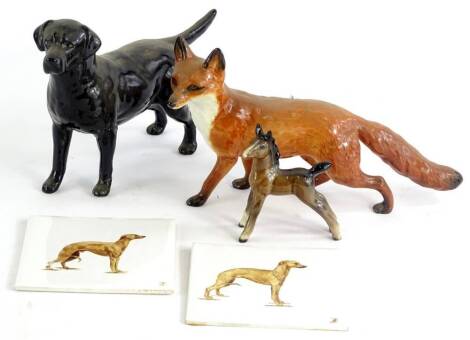 A collection of ceramics, to include a Beswick black Labrador, a Beswick fox, a foal and a pair of hand painted ceramics tiles, decorated with whippets.