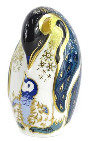 A Royal Crown Derby porcelain penguin and chick paperweight, gold button, boxed.