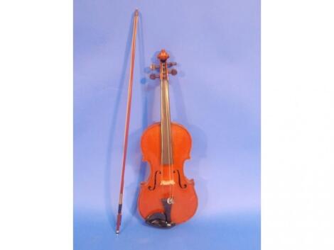 A 19thC violin with two piece figured back and rosewood pegs bears a label