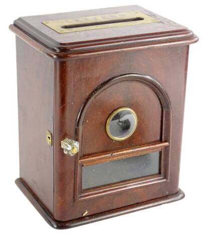 A small mahogany cabinet, the door with an arched panel, inset with a roundel and a rectangular glazed panel, 28cm H.