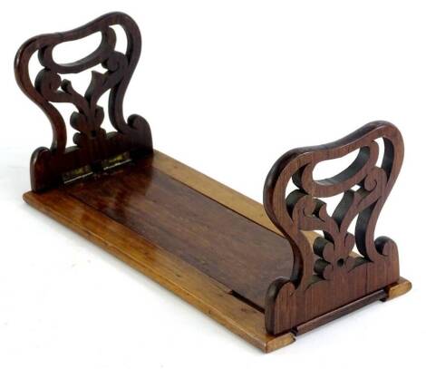 A late Victorian rosewood adjustable book rack, with fret cut hinged uprights, 30cm W. (when closed)