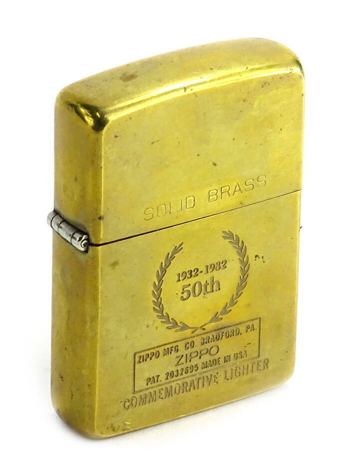 A Zippo brass lighter, made to commemorate the 50th Anniversary in 