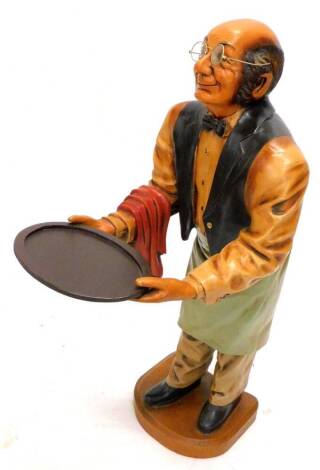 A painted composition figure of a waiter, holding an oval tray, 95cm H.