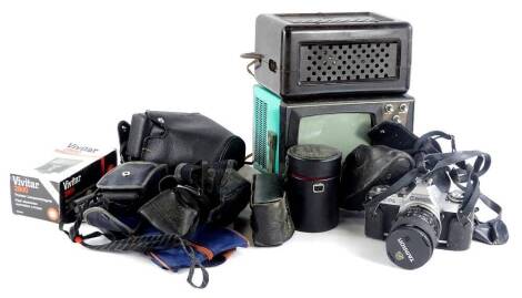 Various Canon cameras, a lens, a small portable television, Bakelite radio, etc.