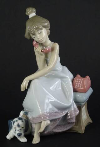 A Lladro figure of a young girl, with a telephone beside a dog titled Chit Chat, in fitted box.