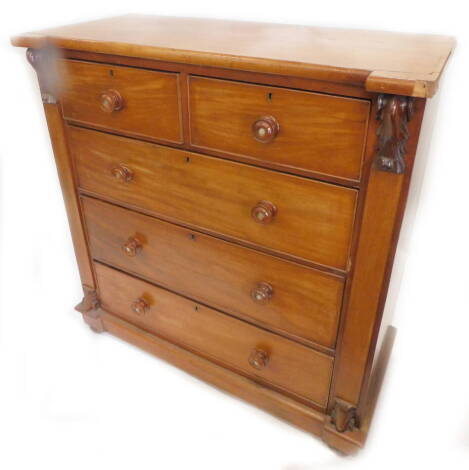 A Victorian mahogany chest of drawers, with two short, three long drawers, with turned wood handles, centred with mother of pearl, flanked by carved bosses on bun feet, (AF), 110cm W.