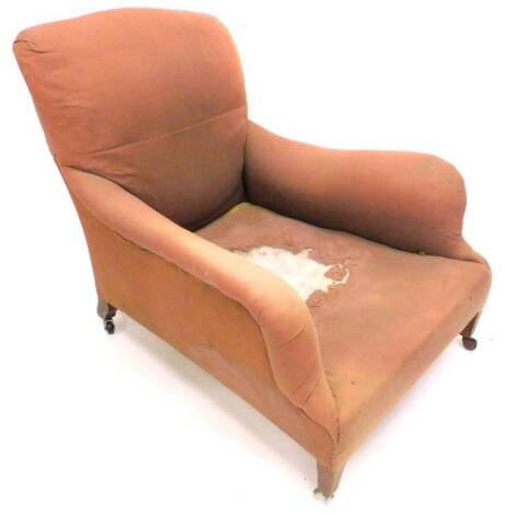 A late Victorian deep seated armchair in the style of Howard, with later castors.