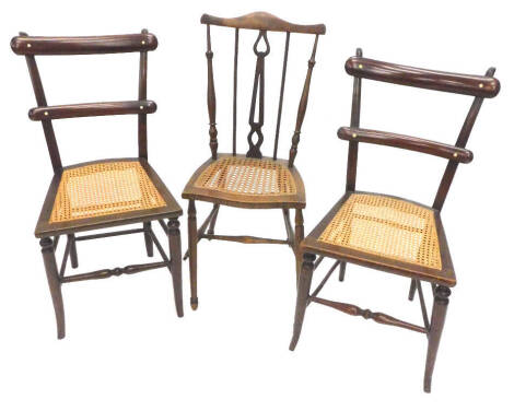 A pair of Victorian mahogany bedroom chairs, each with a cane seat, and a similar bedroom chair.