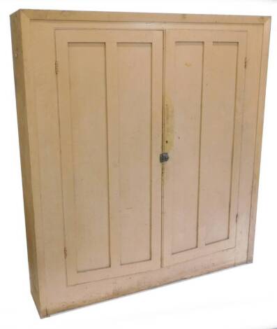 A 19thC pine estate type cupboard, with later paint, the two panelled doors enclosing a series of shelves, lacking back, 190cm H, 174cm W.