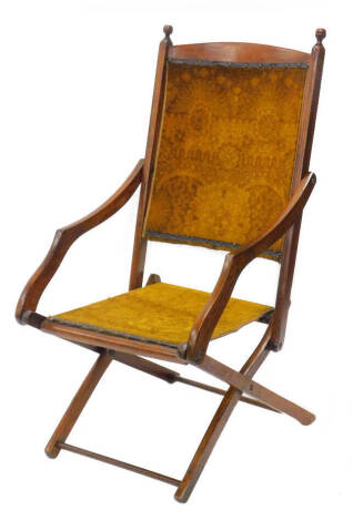 A late 19thC campaign type folding chair, with a carpet type back and seat, on egg shaped support.