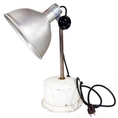 A vintage early 20thC industrial lamp, with silver coloured shade and plain cylindrical stem, on a circular base painted cream, unmarked, 61cm H.