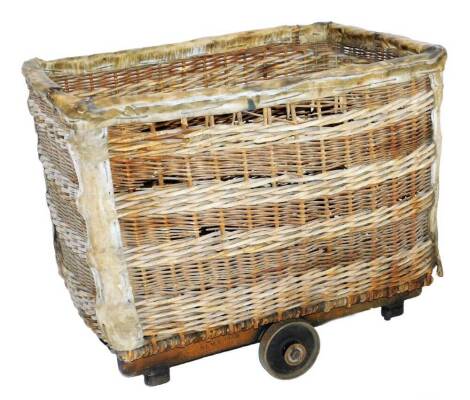 A very early 20thC wicker basket, of large proportion, the rounded top with pig skin mounts, 67cm H, 105cm W, 76cm D.