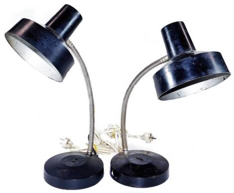 A pair of vintage mid 20thC industrial angle poise lamps, each with shaped shades in black with adjustable stems on circular feet, 53cm H. (2)