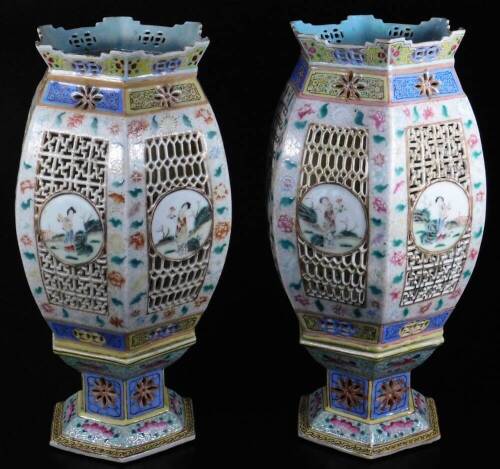 A fine pair of Chinese reticulated porcelain table lanterns, each of octagonal globular form, the bodies partially pierced and set with hand painted panels of figures in exterior settings, to include a lady dressed in finery, surrounded by floral border,