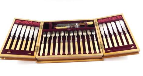 A Victorian silver plate and ivory fish canteen of cutlery, contained in a burr walnut, mahogany and satin wood case, Rd no. 507, comprising pair of fish servers, and twelve knives and forks with silver ferrules, with key, case 42cm W x 32cm D.