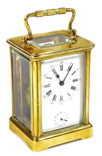 An early 20thC brass carriage clock, of rectangular form, with a five sectional glass case and swing handle, with 5cm W Roman numeric dial and subsidiary Arabic second hand, with an open keywind movement, striking on a bell, with plain back plate numbered