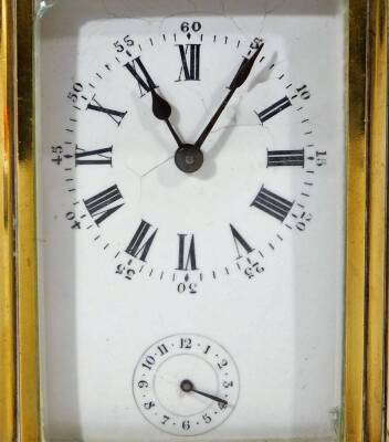 An early 20thC brass carriage clock, of rectangular form, with a five sectional glass case and swing handle, with 5cm W Roman numeric dial and subsidiary Arabic second hand, with an open keywind movement, striking on a bell, with plain back plate numbered - 2