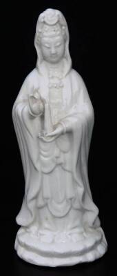 A Chinese blanc de chine porcelain figure, of a lady standing in flowing robes holding candle, on a shaped base (hollow), 15cm H.