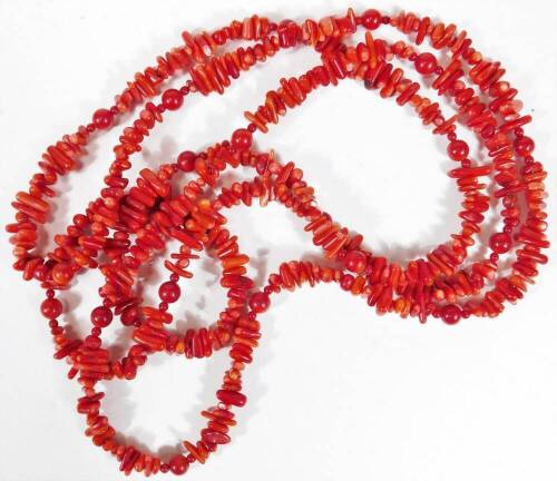 A coral necklace, with design of spherical and oblong beads, on a longuard chain, 75cm L overall.