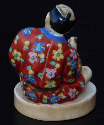 An early 20th Japanese pottery figure, of a gentleman seated in flowing robes, florally decorated predominately in yellow, blue and red, on a circular foot, impressed mark JAPAN beneath, 9cm H. - 3