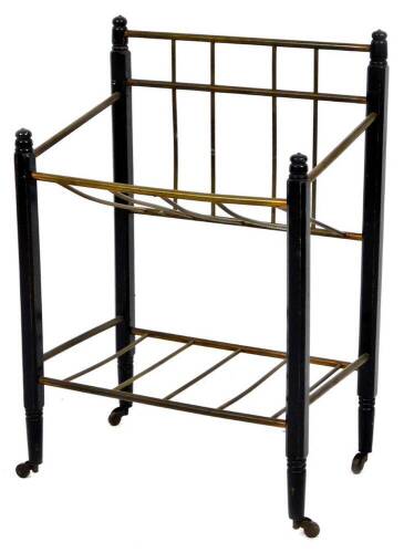 A 20thC metal newspaper rack, with turned sections and ebonised frame work, 62cm H, 42cm W, 31cm D.