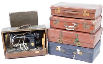 An early 20thC brown leather travel case, with metal locks and studded corners, 56cm W, a Revelation travel case, two others and an electric sewing machine. (a quantity)