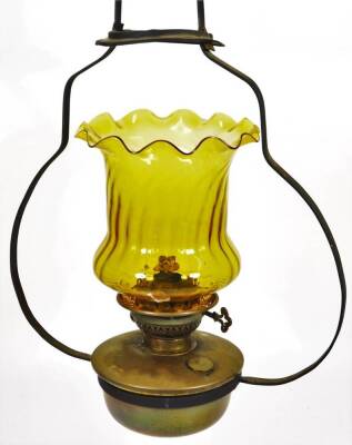 A metal framed hanging lantern, with 21cm H amber coloured shade and brass reservoir.