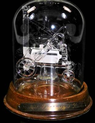 A Lymington's glass Mystic Ltd Stephenson's Rocket in a bottle, 31cm H, on oak stand. - 2