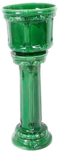 A late 19thC Majolica jardiniere on stand, in green glazes, with moulded jardiniere, on separate cylindrical stem and circular foot, 95cm H, the jardiniere 35cm W.