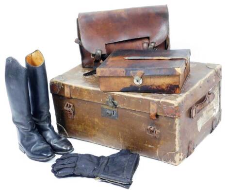 An early 20thC travel trunk, with Wagstaff & Sons, 23 Boscombe Arcade label, of rectangular form, initialled ESO with various part luggage labels, 66cm W, further cases, satchel, a vanity case and a pair of black leather hunting boots. (a quantity)