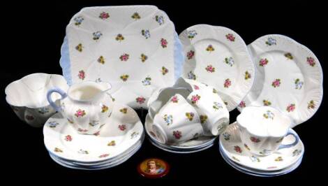 A mid 20thC Shelley porcelain part tea service, in a floral pattern, to include sandwich plate, 23cm W, sugar bowl, cups, saucers, etc. and a continental circular porcelain plaque decorated with a gentleman quarter profile.